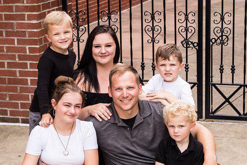 Joyful Family Portrait in Front of Iron Gate